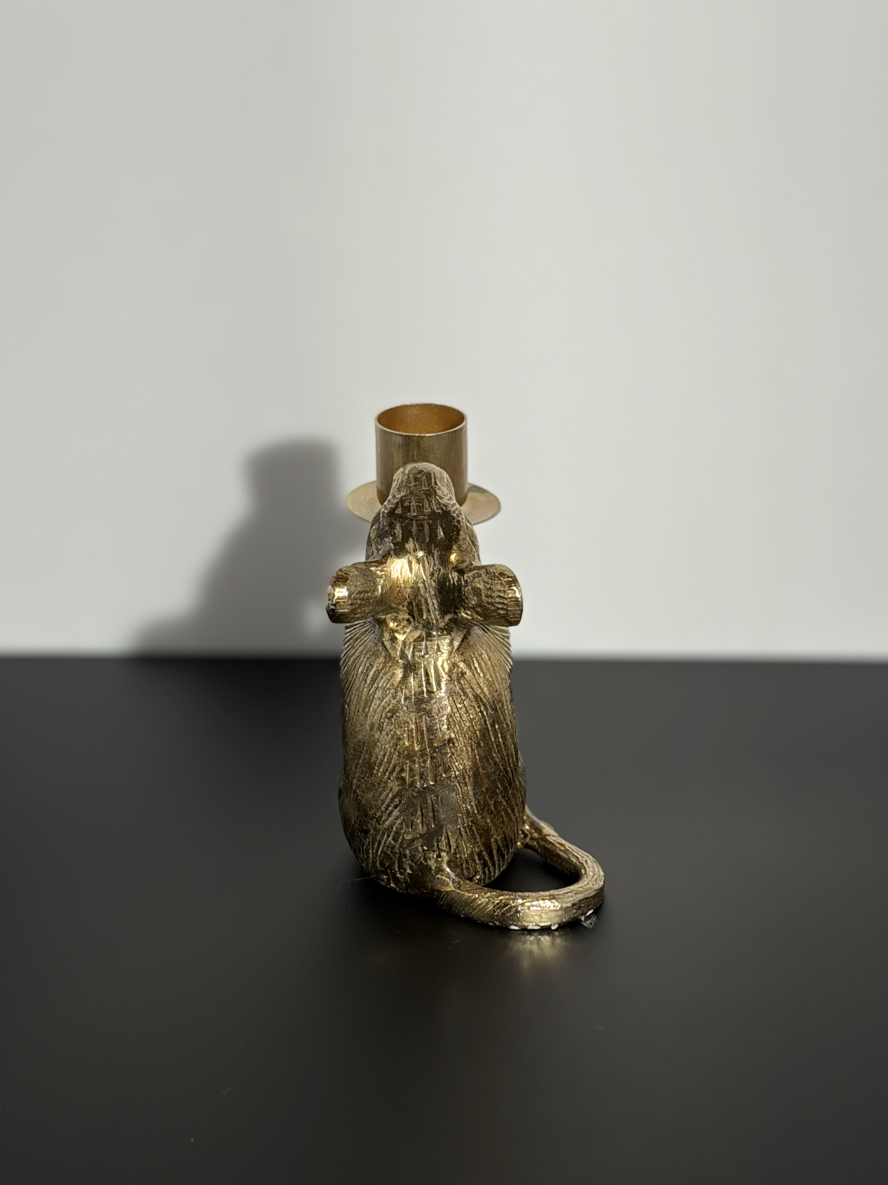 The back of a mouse candle holder