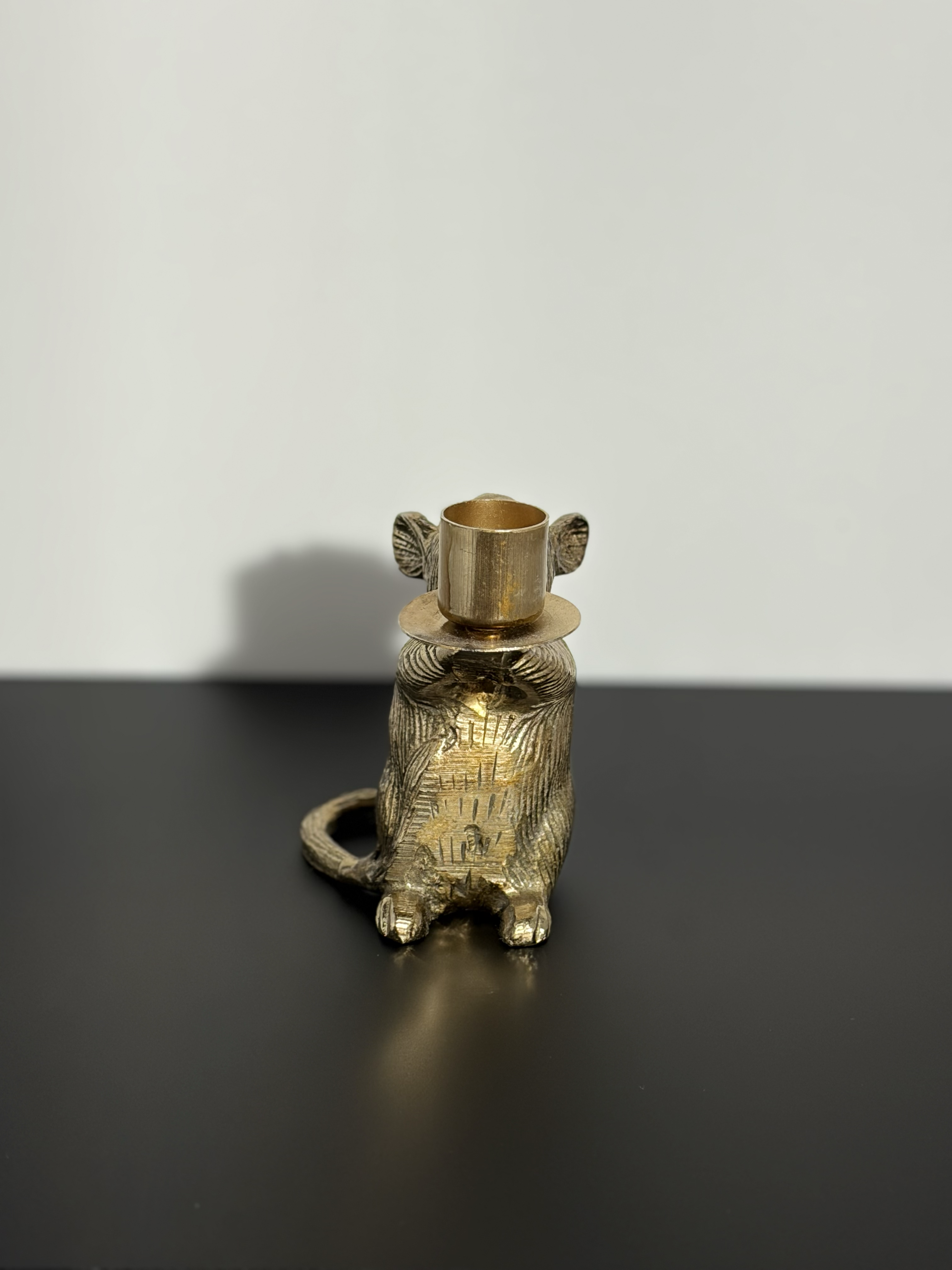 The front of a mouse candle holder
